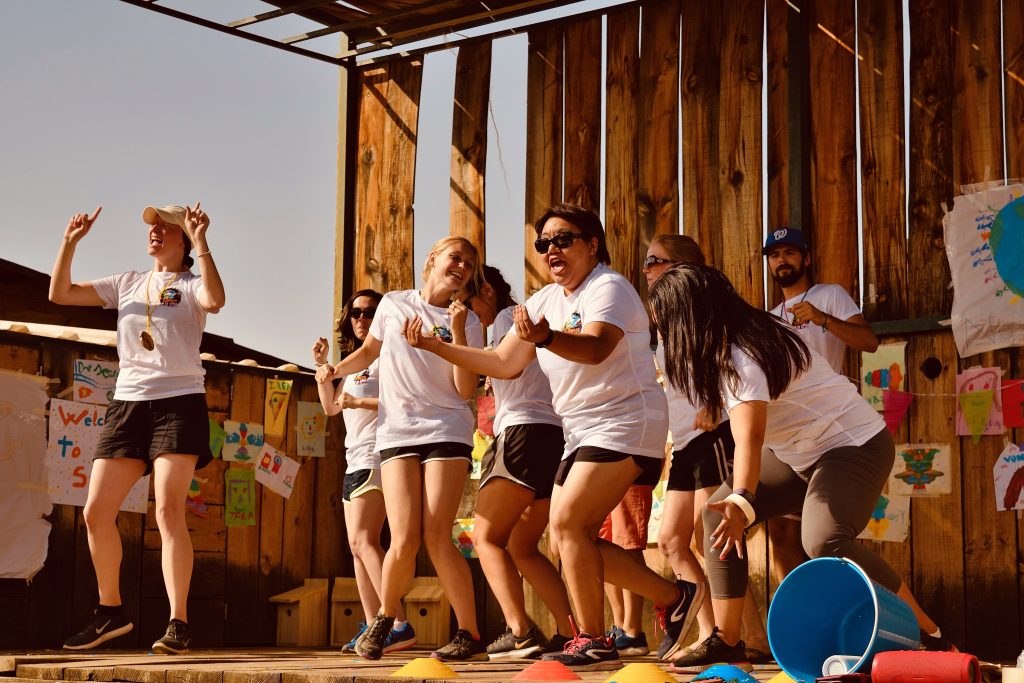 Niños y monitores, celebrando y divirtiéndose en actividades al aire libre en Easytown Summer Camp